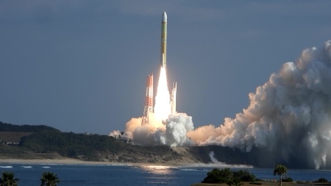 An H3 rocket lifts off from the Tanegashima Space Center by the sea